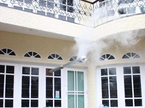 a house with smoke coming out of a balcony at Heritage Rose Inn in Srinagar