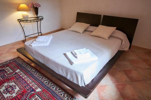 a bedroom with a bed with two towels on it at House on the sea garden in Marsala