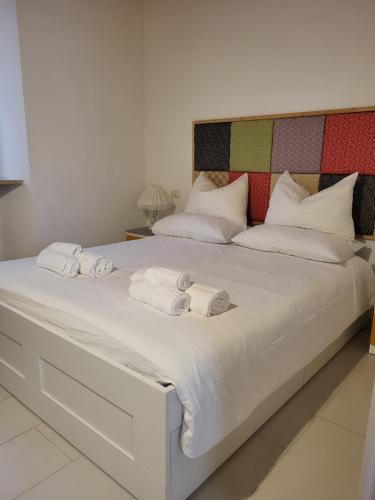 a large white bed with two towels on it at TorreCielo in Foligno