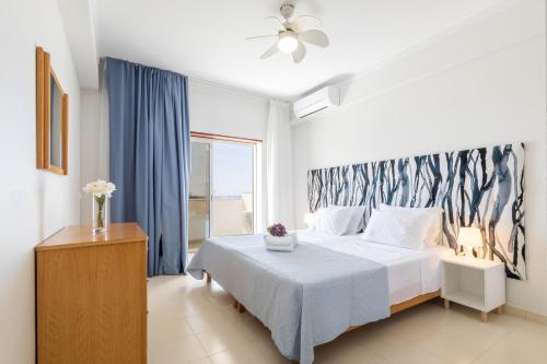 a bedroom with a bed and a large window at Casa Azul 3 - Senhora da Rocha, Algarve in Porches