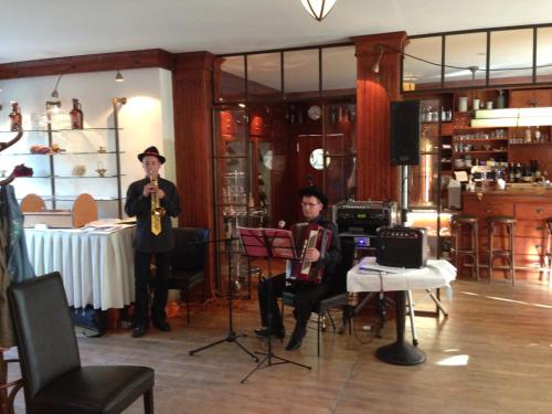a man and woman playing instruments in a room at Romantik Hotel Kaufmannshof in Bergen auf Rügen