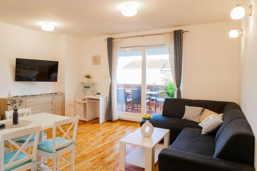a living room with a couch and a table at Apartment Tara in Njivice