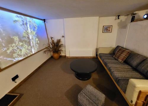 a living room with a couch and a large window at Aviemore Rye in Rye