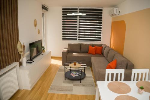 a living room with a couch and a table at Apartment Infinity in Kruševac