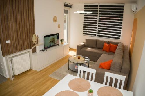 a living room with a couch and a tv at Apartment Infinity in Kruševac