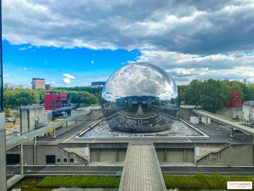 a large glass ball sitting on top of a building at Studio number 10 in Pantin
