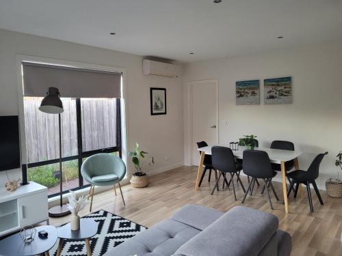 a living room with a couch and a table at Boulder House in Melbourne
