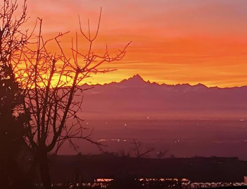 a sunset with a mountain in the background at Langhe Wine & Relax in Novello