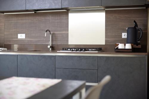 a kitchen with a sink and a counter top at CallaLillyJardin in Malcesine