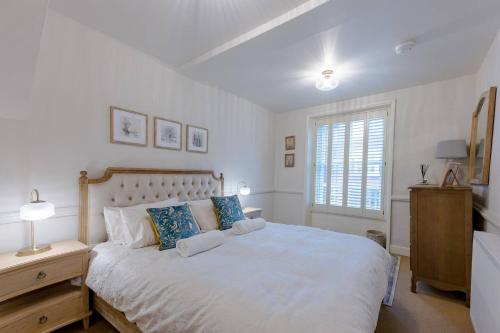een slaapkamer met een groot wit bed en een raam bij Pass the Keys Juno Apartment In the centre of historic Ludlow in Ludlow
