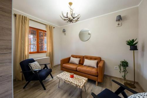 a living room with a couch and a table at Plitvice Village in Korenica