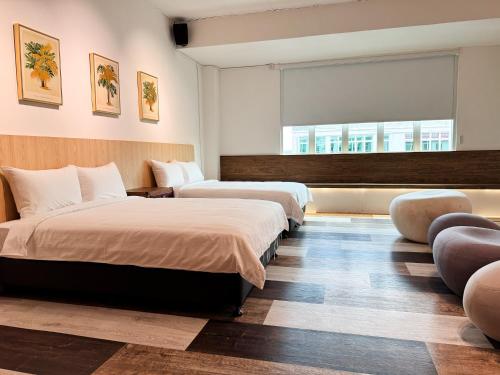 a hotel room with two beds and a window at Inang Street Stay - Cheng Business Park in Melaka