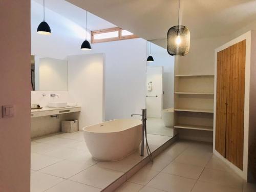 a bathroom with a large tub and a sink at Mansa Marina Hotel in Mindelo