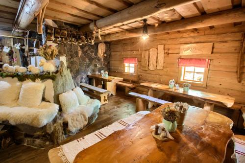 a room with a table and chairs in a cabin at Penzión Zbojnícky Halaš in Tisovec