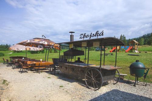 a horse drawn carriage with a playground in the background at Penzión Zbojnícky Halaš in Tisovec