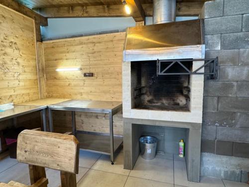 a kitchen with an oven and a table and a counter at Chata pod Mníchom in Terchová