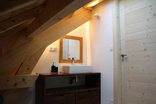 a bathroom with a sink and a mirror at chalet montagne la lupina in Les Orres