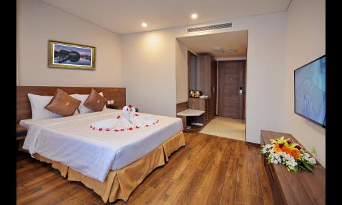 a hotel room with a bed with a cake on it at Lenid Ocean View Hotel in Nha Trang