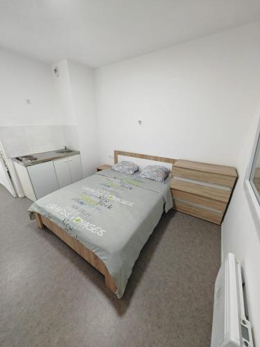 a bedroom with a bed in a white room at Aladin resort in Bouconvillers