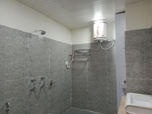 a bathroom with a shower with a toilet and a sink at Hotel bhargav residency in Sāmba