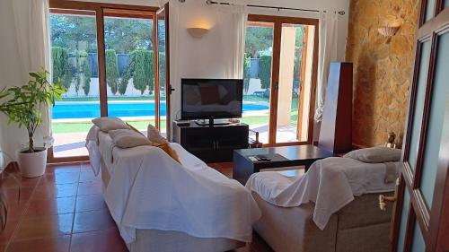 a living room with couches and a tv at Villa Puerto Adriano in El Toro