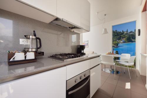 a kitchen with a stove and a counter top at CallaLillyJardin in Malcesine