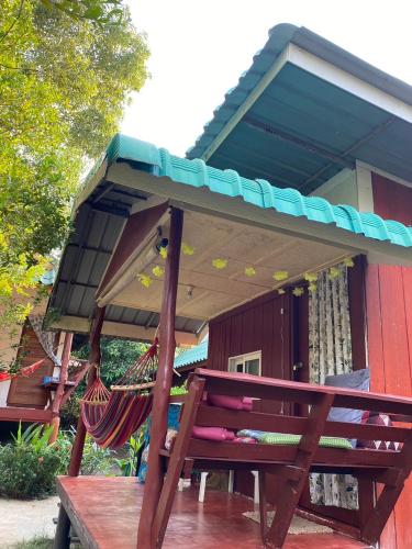 a porch with a hammock and a house at LONELY GROOVE in Ko Chang
