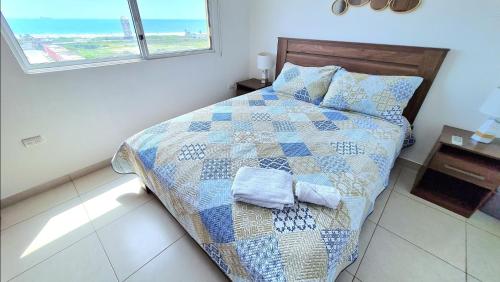 a bedroom with a bed with a quilt on it at Suite con Vista al Mar, Piscinas, Jacuzzi, Wifi in Playas