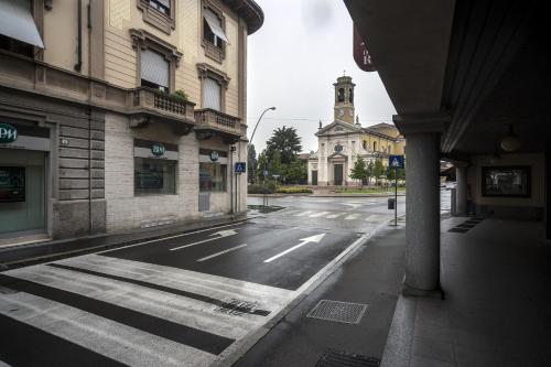 an empty city street with a church in the background at Hotel Del Riale in Parabiago