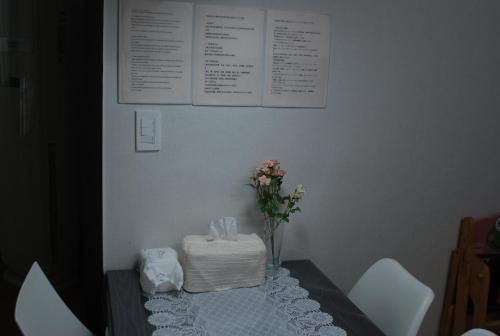 a table with a cake and flowers on top of it at Pyeongtaek Tarot 2 House Camp Humphreys 워킹게이트 도보10분 in Pyeongtaek