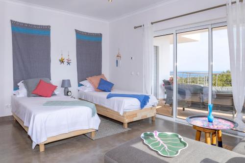 Postel nebo postele na pokoji v ubytování Villa Céu Do Sul