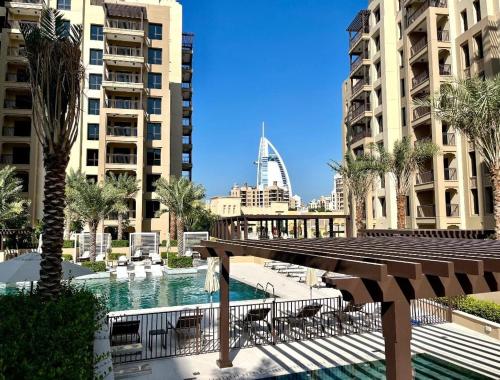 a view of a pool in a city with buildings at Brand new 2 Bedroom apartment in Madinat Jumeirah Living in Dubai