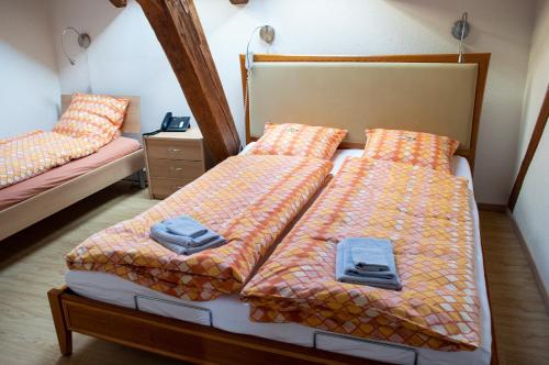 a bedroom with two beds and a couch and a bed at Ferienwohnungen Hotel Eden Spiez in Spiez