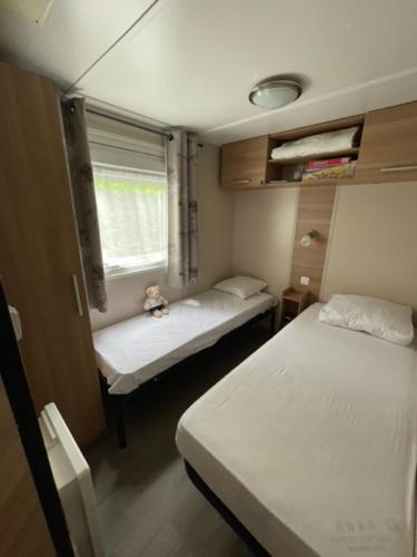 a small room with two beds and a window at GHVacances PiPiou Lac de Parentis en Born in Parentis-en-Born