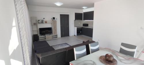 a kitchen and living room with a table and chairs at Valemar Apartments in Pomorie