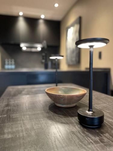 a wooden table with a bowl on top of it at Luxury Warehouse District Condo in Durham