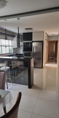 a kitchen with stainless steel appliances and a table at casa entero piscina privada in Aparecida de Goiania