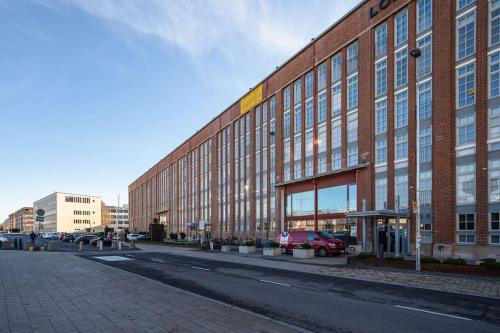 a large brick building on the side of a street at Historical place by the river Aura in Turku