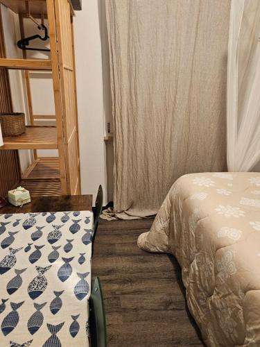 a bedroom with a bed with a blanket on the floor at VILLA VILLACOLLE in Procchio