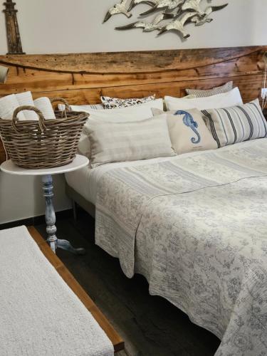 a bedroom with two beds and a basket on a table at VILLA VILLACOLLE in Procchio