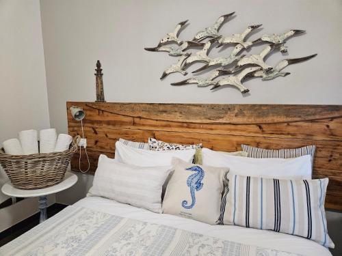 a bedroom with a bed with a wooden headboard at VILLA VILLACOLLE in Procchio