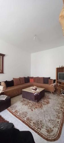a living room with a couch and a table at Le Kram House in La Goulette