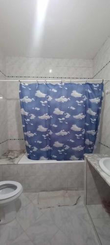 a bathroom with a shower curtain with clouds at Le Kram House in La Goulette