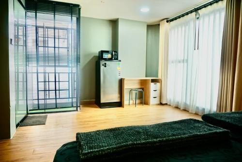 a living room with a refrigerator and a table at Hip and funky apartment silom Soi 3, with rooftop view in Bangkok