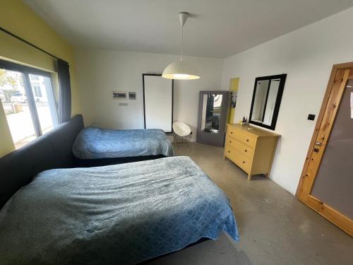 a bedroom with two beds and a dresser and a mirror at Cozy Flat in Heart of Nicosia in Lefkosa Turk
