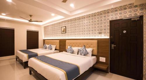 a bedroom with two beds in a room at SMA Grand inn, Triplicane in Chennai