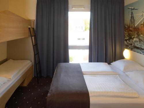 Postel nebo postele na pokoji v ubytování B&B Hotel Kiel-Wissenschaftspark