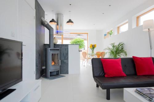 a living room with a couch and a fireplace at King Bed Joy Lane, Chichester near Goodwood in Chichester