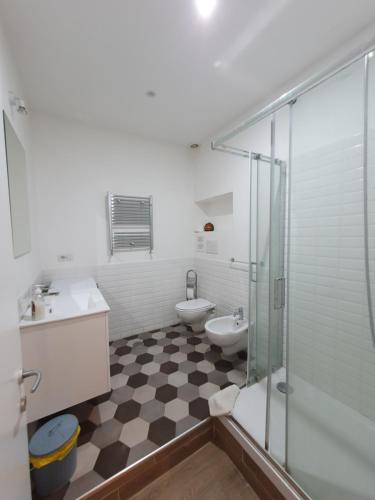 a bathroom with a toilet and a sink and a shower at La Casa a Trastevere in Rome