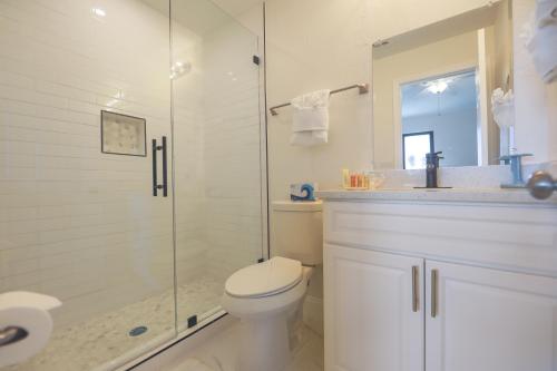 a bathroom with a toilet and a glass shower at LAKE PALMS 1 in Sanibel